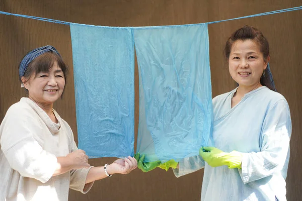 Japanese Senior Women Holding Indigo Dyed Silk — стоковое фото