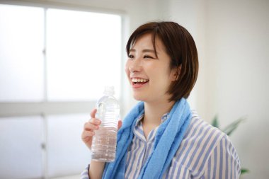 Spor salonundaki antremandan sonra suda bir kadın.