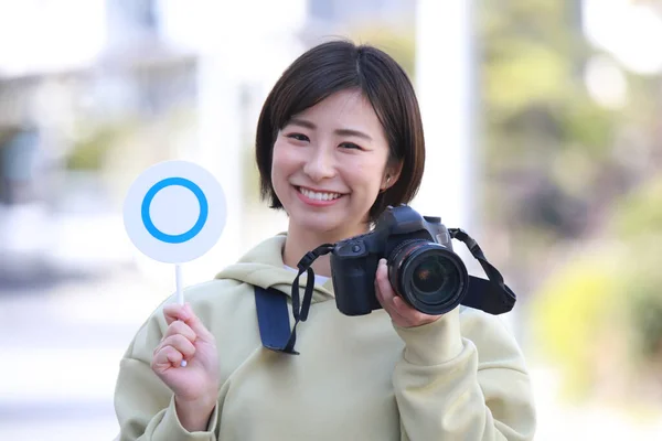 Eine Frau Mit Einer Spiegelreflexkamera Und Einem Tag — Stockfoto