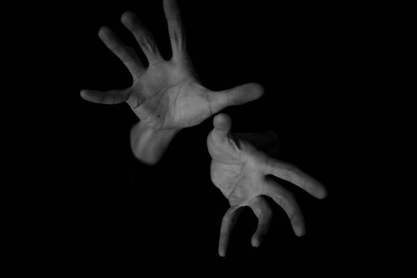 hands of a man on dark background