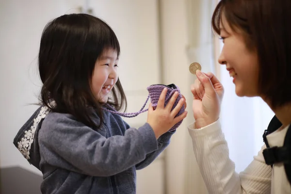 Image of a girl receiving pocket money