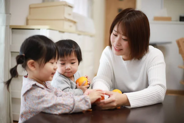 Glückliche Mutter Schaut Kinder Die Hause Orangen Halten — Stockfoto