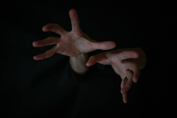 hands of a man on dark background