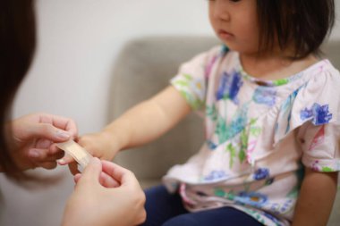 Alçı yapıştıran bir kız resmi