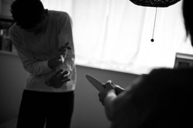  Arkadan bıçaklanmış bir adam ve korkmuş kadın.