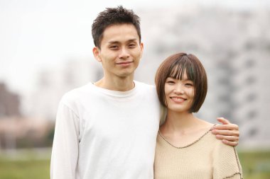 Genç Asyalı çift, erkek ve kadın açık havada.