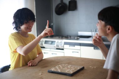 Mutlu Asyalı çift masa oyunu oynuyor.