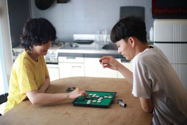 Mutlu Asyalı çift Go masa oyunu oynuyor