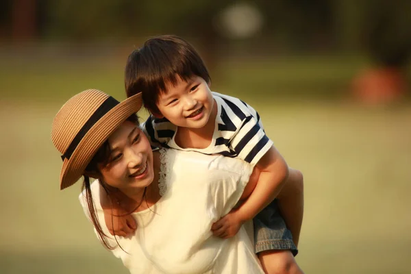 快乐的母亲和儿子在公园里摆姿势 — 图库照片