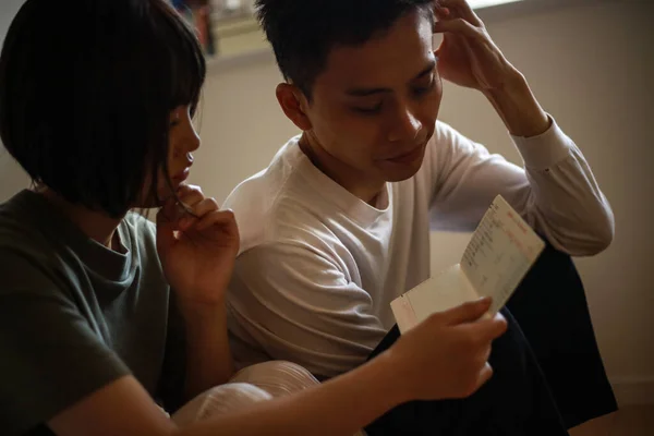 Couple Worried While Looking Passbook — 图库照片