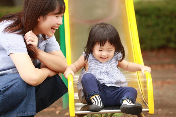 Anne ve kızı oyun alanında oynuyorlar.