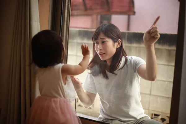 Young Asian Mother Looking Window Little Daughter Home — Stock Photo, Image