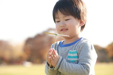 Parktaki yakışıklı Asyalı çocuk.