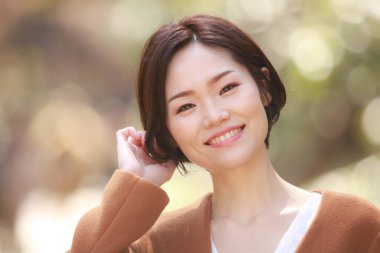 Parkta poz veren genç Asyalı kadın. 