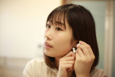 Asyalı genç bir kadının portresi. Kulak delici.