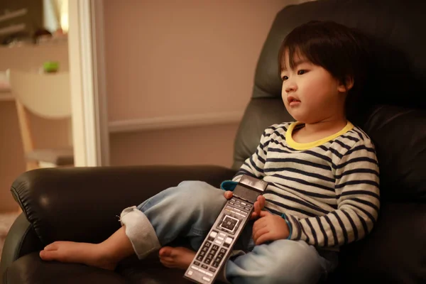 Słodkie Małe Dziecko Siedzi Kanapie Ogląda Telewizję — Zdjęcie stockowe