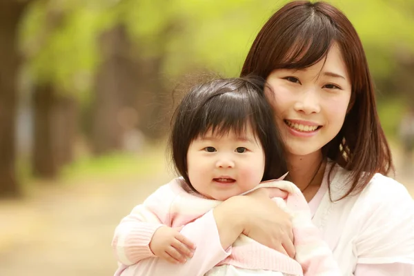 かわいいアジア系の女の子と彼女のお母さんは公園で — ストック写真