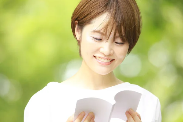 年轻的亚洲女人读的书 — 图库照片