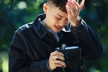 Elinde video kamera olan hasta bir adam.