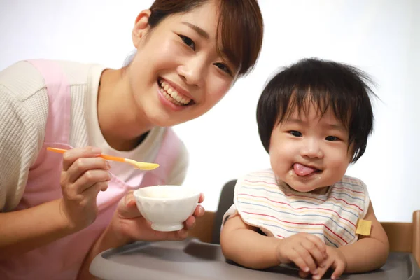 Happy Asian Mother Feeding Her Little Son Rice — Stock Photo, Image