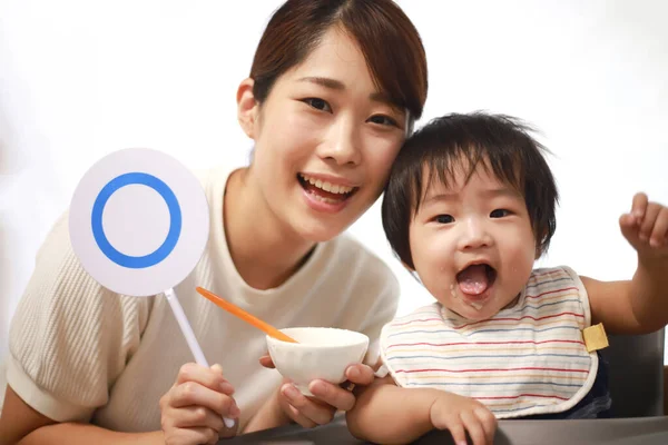 Happy Asian Mother Feeding Her Little Son Rice — Stock Photo, Image