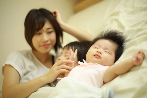 Happy Asian Mother Looking Sleeping Son Daughter — Stock Photo, Image