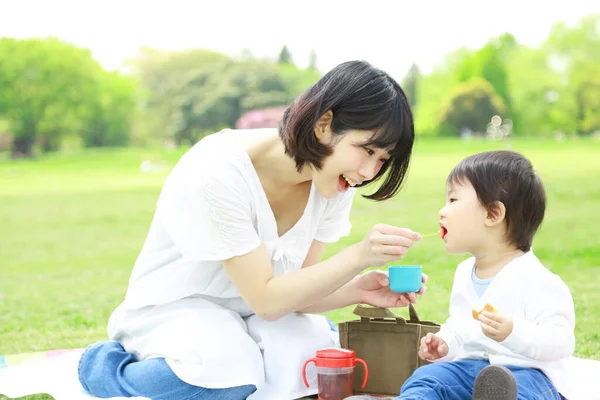 Young Asian Mother Her Child Eating Park Royalty Free Stock Images