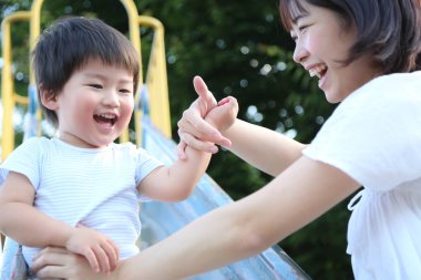 Asyalı anne ve oğlu oyun parkında