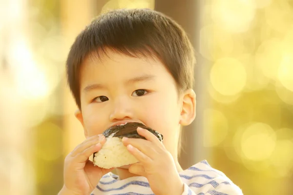 Ένα Ασιατικό Αγοράκι Τρώει Ένα Ντόνατ Στο Πάρκο — Φωτογραφία Αρχείου
