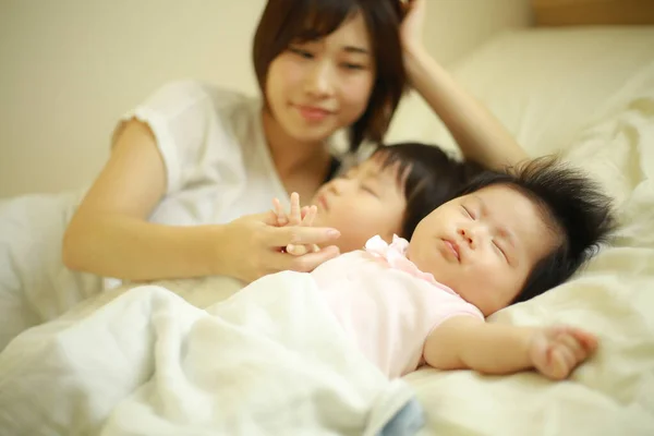 Happy Asian Mother Looking Sleeping Son Daughter — Stock Photo, Image