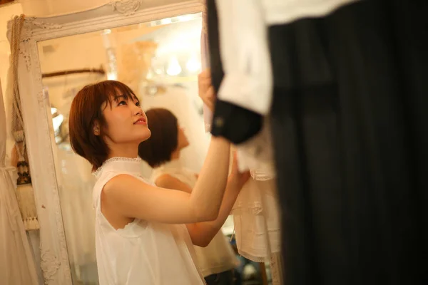Beautiful Young Asian Woman Choosing Clothes — Stock Photo, Image