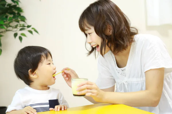 Happy Asian Mother Feeding Her Little Son Rice — Stock Photo, Image