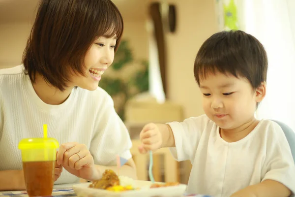 Asyalı Genç Kadın Küçük Oğlu Masada Yemek Yiyorlar — Stok fotoğraf