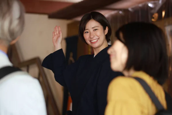 Χαμογελαστός Ιάπωνας Ρεσεψιονίστ Που Δείχνει Δωμάτιο Ξενοδοχείου Για Ηλικιωμένο Ζευγάρι — Φωτογραφία Αρχείου