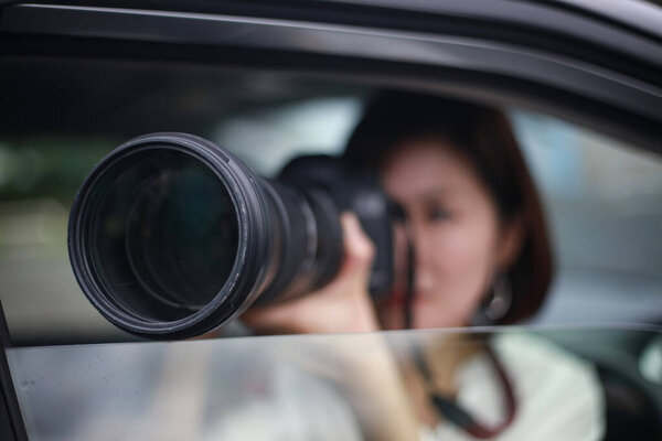  beautiful asian young woman  with camera in the car, paparazzi