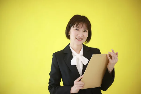 Businesswoman Holding Folder Isolated Yellow — Stock Photo, Image