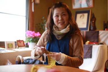 Image of a woman knitting  clipart