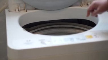 Çamaşır makinesini çeviren kadın