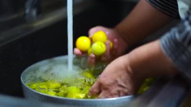 Image of a woman washing plums