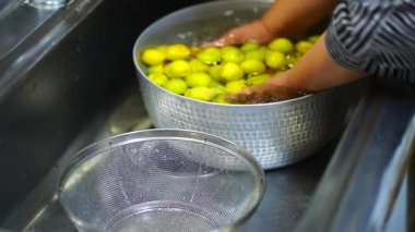 Image of a woman washing plums