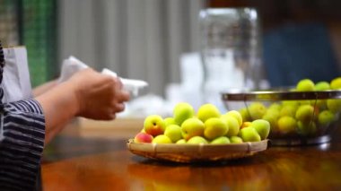 A woman who drains the washed plums