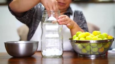 Woman making plum syrup