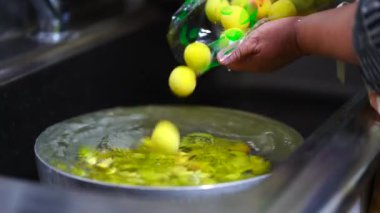 Image of a woman washing plums