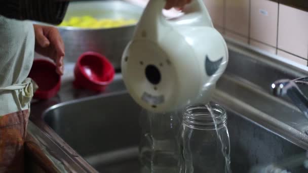 Woman Disinfecting Bottles Boiling Water — Stok video