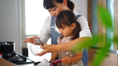 Parents and children boiling apples