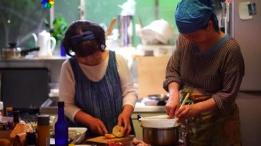 Woman rubbing boiled plums