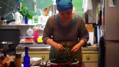 Woman picking red perilla leaves