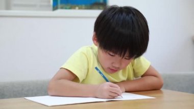 Çocuk evde çalışıyor.