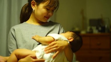 Anne çocuğunu uyutuyor.