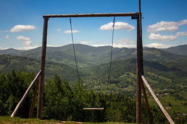Swing on the edge of a mountain cliff in the Carpathians